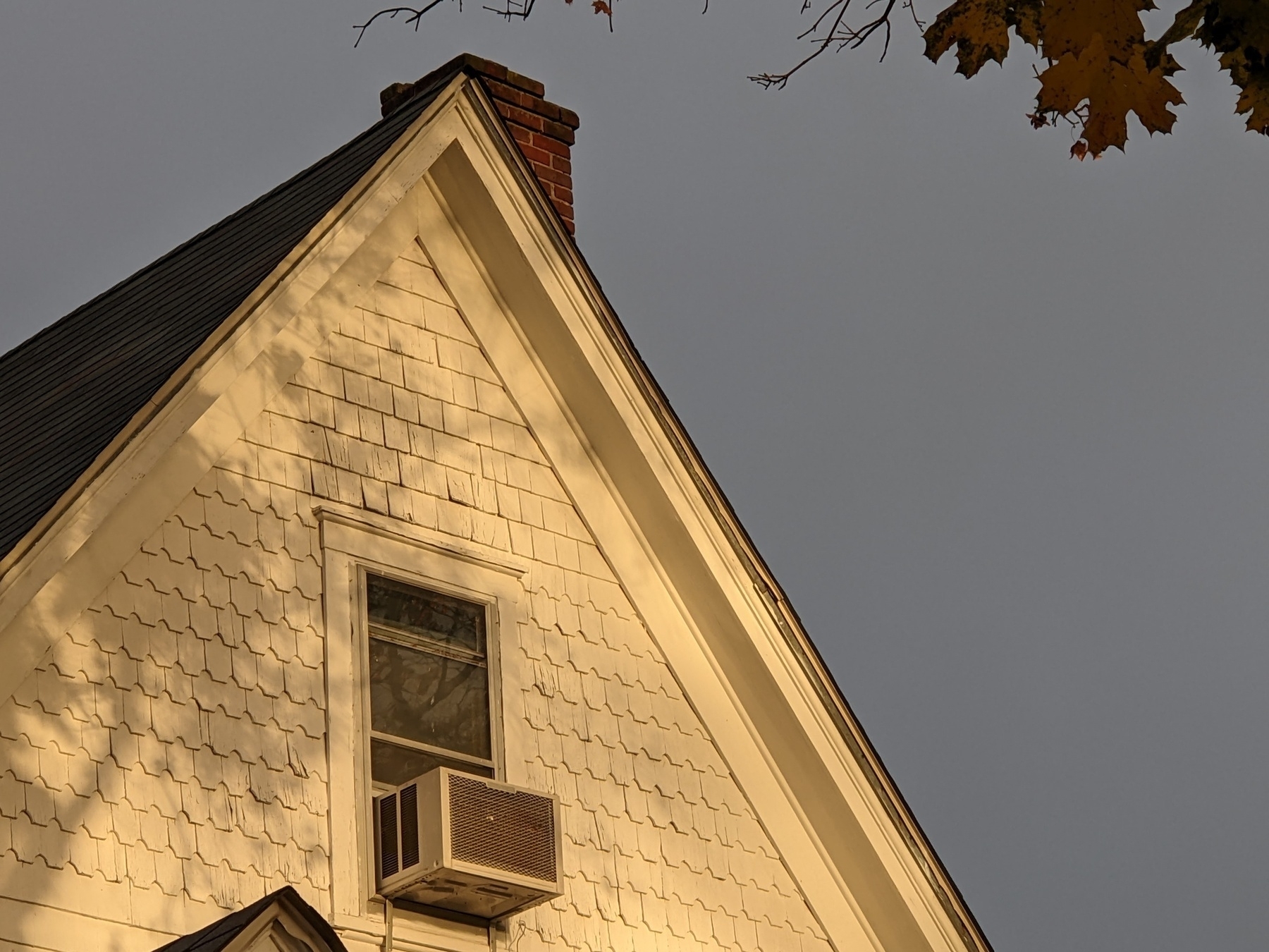 gable of a Victorian house, in hazy morning light